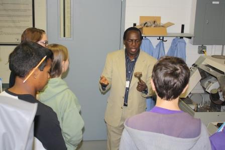 Penn State DuBois Assistant Professor of Engineering Daudi Waryoba explains the production process of powder metal parts used in the automotive industry during a Manufacturing Day presentation. (Provided photo)