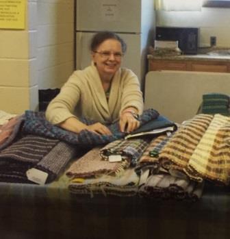 One of the vendors, Robin Greendoner, is pictured showing her homemade rugs. (Provided photo)