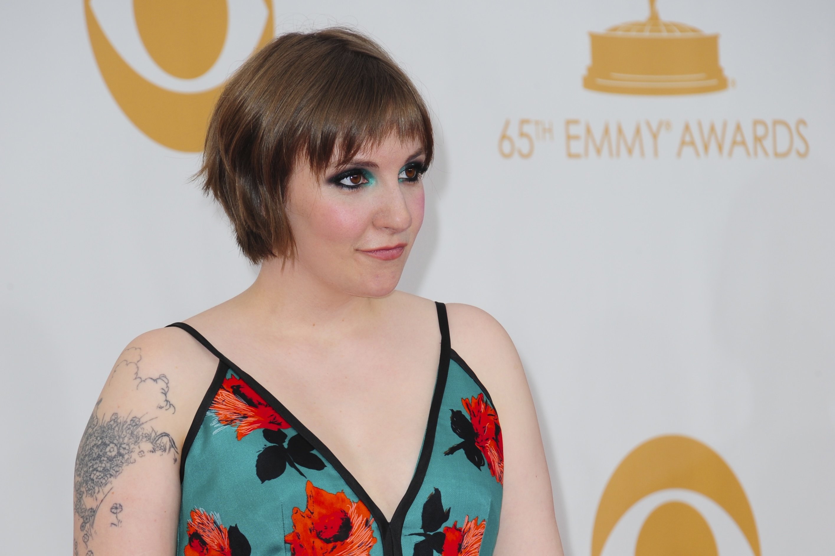 Actress Lena Dunham poses on the red carpet before attending the 65th Annual Primetime Emmy Awards in Los Angeles, California on September 22, 2013.