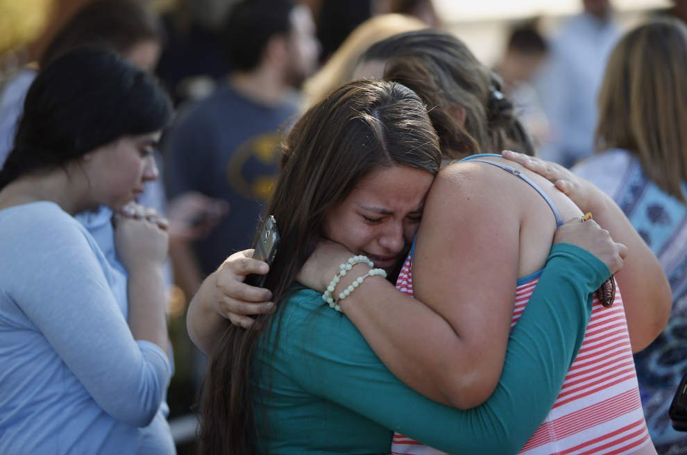 Students hug after a shooting at Oregon's Umpqua Community College in Roseburg on Thursday. 

http://registerguard.com/rg/news/local/33566342-75/13-reported-dead-20-injured-in-shooting-at-umpqua-community-college-in-roseburg-male-gunman-dead.html.csp