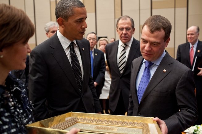 President Barack Obama and President Dmitry Medvedev of the Russian Federation exchange gifts following their bilateral meeting at the Millennium Seoul Hilton in Seoul, Republic of Korea, March 26, 2012. Ambassador Capricia Marshall, U.S. Chief of Protocol, left, holds the gift. (Official White House Photo by Pete Souza)