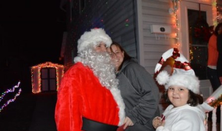 Santa receives a hug from Lea Patterson of Clearfield Borough's Fourth Ward during the Clearfield Volunteer Fire Department's annual Santa Tour. Patterson was given a gift card from Santa for being selected as the house in Fourth Ward with the best Christmas decorations. One winner was chosen from each ward by the fire department. (Photo by Kimberly Finnigan)