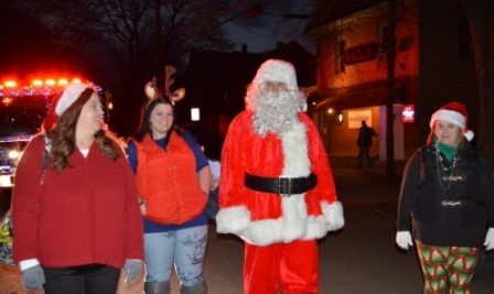Santa, Mrs. Claus and two helpers take to the streets of Clearfield Borough during the Clearfield Volunteer Fire Department's annual Santa Tour. The fire department members passed out goodie bags to children throughout the borough on Saturday night. (Photo by Kimberly Finnigan)