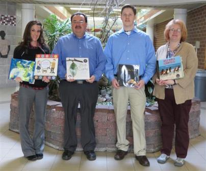 Shown, from left, are DAMS Principal Wendy Benton, Bob Johnson Subaru Sales Manager, Rick DeSalve, Penn State Intern, Bill Swatsworth and DAMS Librarian Julie Baun displaying some of the books that Bob Johnson Subaru donated to the school as part of the Subaru Love of Learning program. (Provided photo)