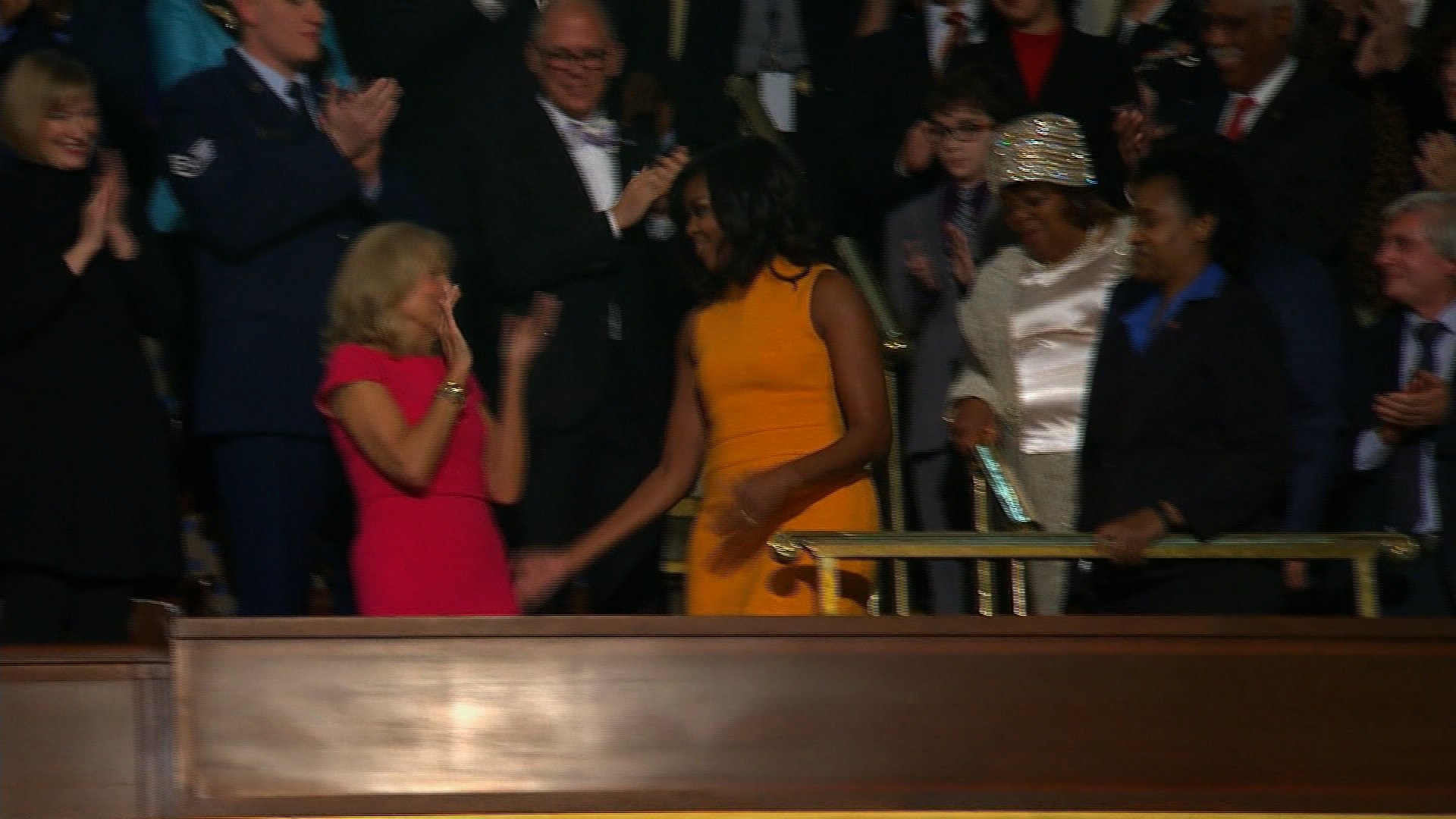 First Lady Michelle Obama greets Jill Biden, wife of Vice President Joe Biden before President Obama's final state of the union address.