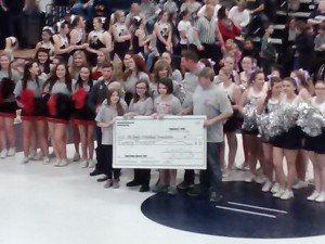 The check presentation at intermission of the Takedown Cancer Match (Photo by Jay Siegel)