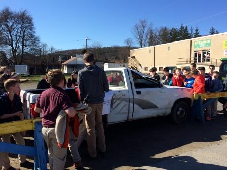 Students are signing the wreck vehicle, making a pledge to not ride with an impaired driver or drive when impaired.  They also pledged to always wear their seatbelts while in a vehicle. (Provided photo)