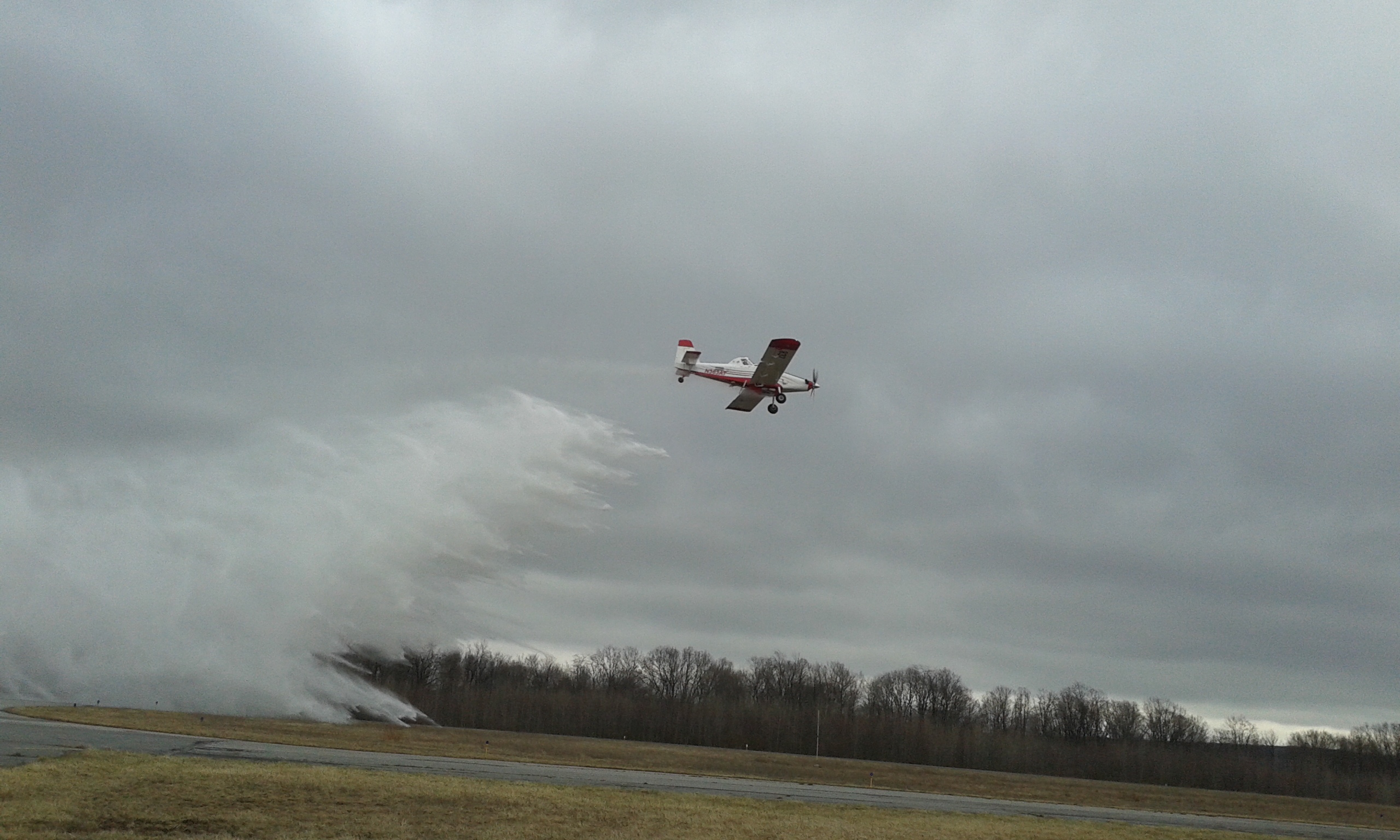 An Airtractor 802 single engine airtanker drops water during a demonstration at Mid-State Airport in the Moshannon State Forest Friday. The airtanker will be officially placed in service Saturday in preparation for wildfire season. The mild winter and dry, windy conditions have contributed to an early start to wildfire season. (Photo by Kimberly Finnigan)