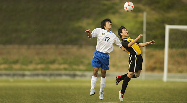 Soccer Players Competing for the Ball