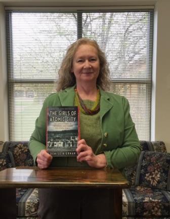 Picture shows Gayle Gearhart, artistic director of CAST Inc., with her copy of The Girls of Atomic City. (Provided photo)