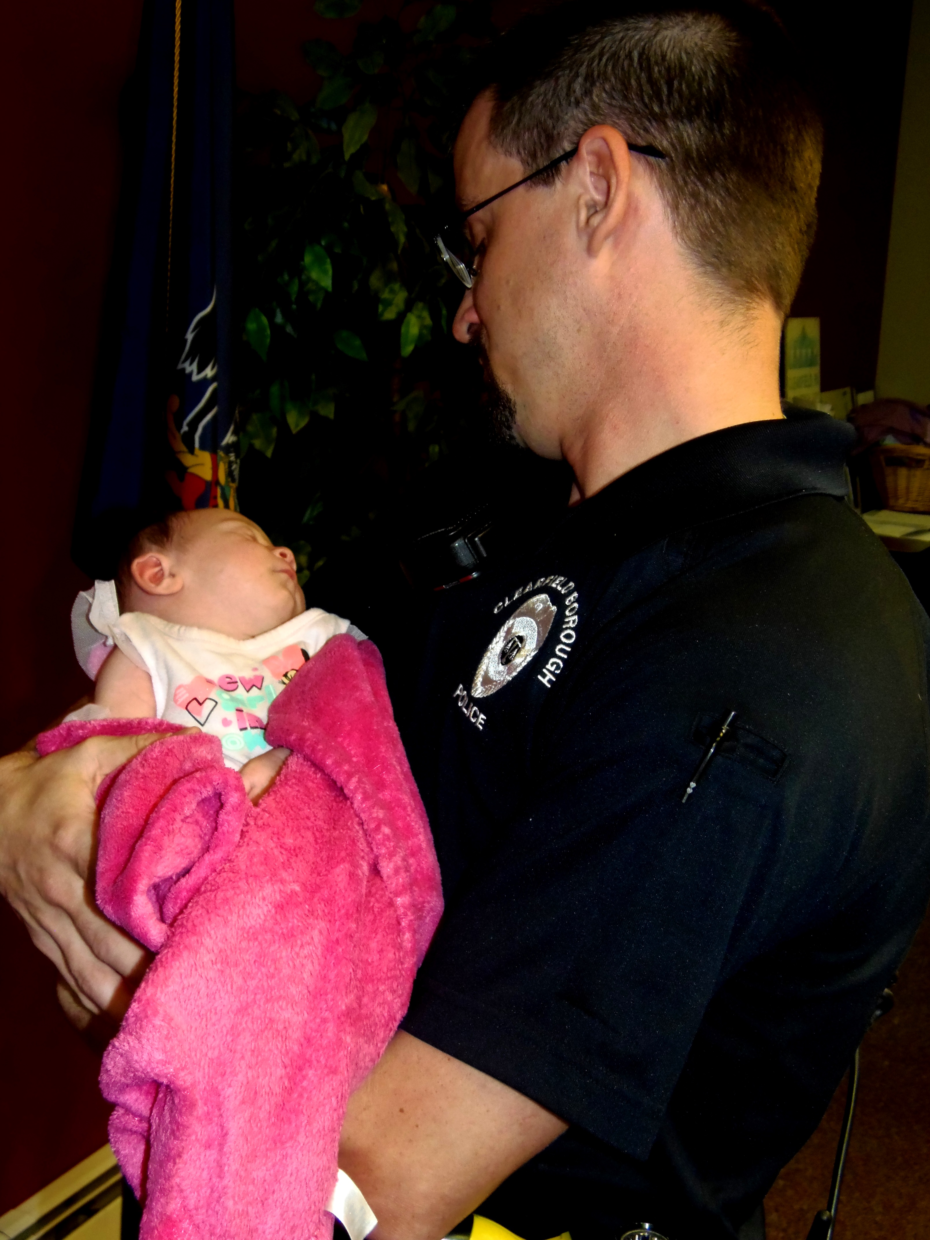 Officer Nathan Curry of Clearfield Borough police is shown holding baby Kiara. (Photo by Jessica Shirey)