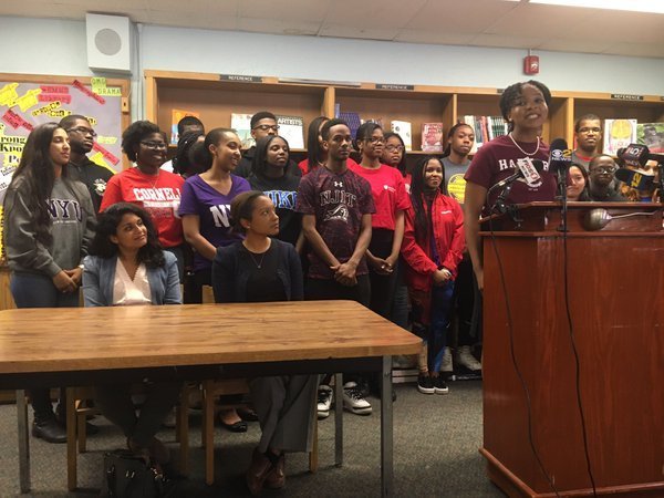 Surrounded by her classmates donning their own college choice T-shirts, Augusta Uwamanzu-Nna approached the podium and unzipped the black jacket she was wearing to reveal a crimson T-shirt revealing her decision: Harvard.
