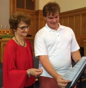 Patty Coldiron, director of the Valley Voices, and Mason Strouse, director of the Clearfield Choral Society, discuss music for their upcoming concert. (Provided photo)