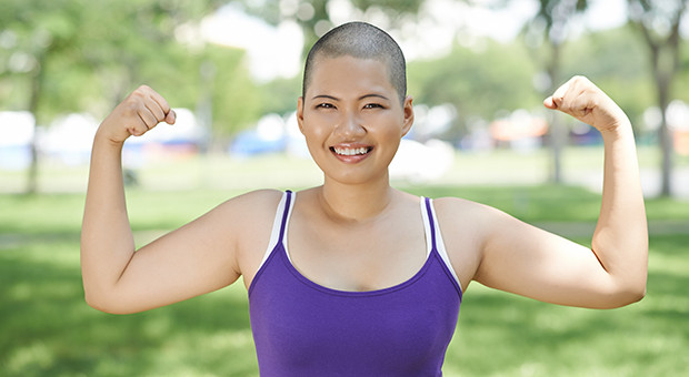 Portrait of sporty Asian woman showing her biceps