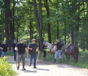 A pair of horses and their riders are ready for action during a mock search exercise Saturday. Members of the Clearfield County sheriff's Posse participated in the drill, a search in a heavily-wooded area for a missing child. The searchers were warned to dress not only for the forest, but for other dangers, like rattlesnakes. About 187 Posse members participated in the drill, and the child was safely located in about half an hour. (Photo by Kimberly Finnigan)