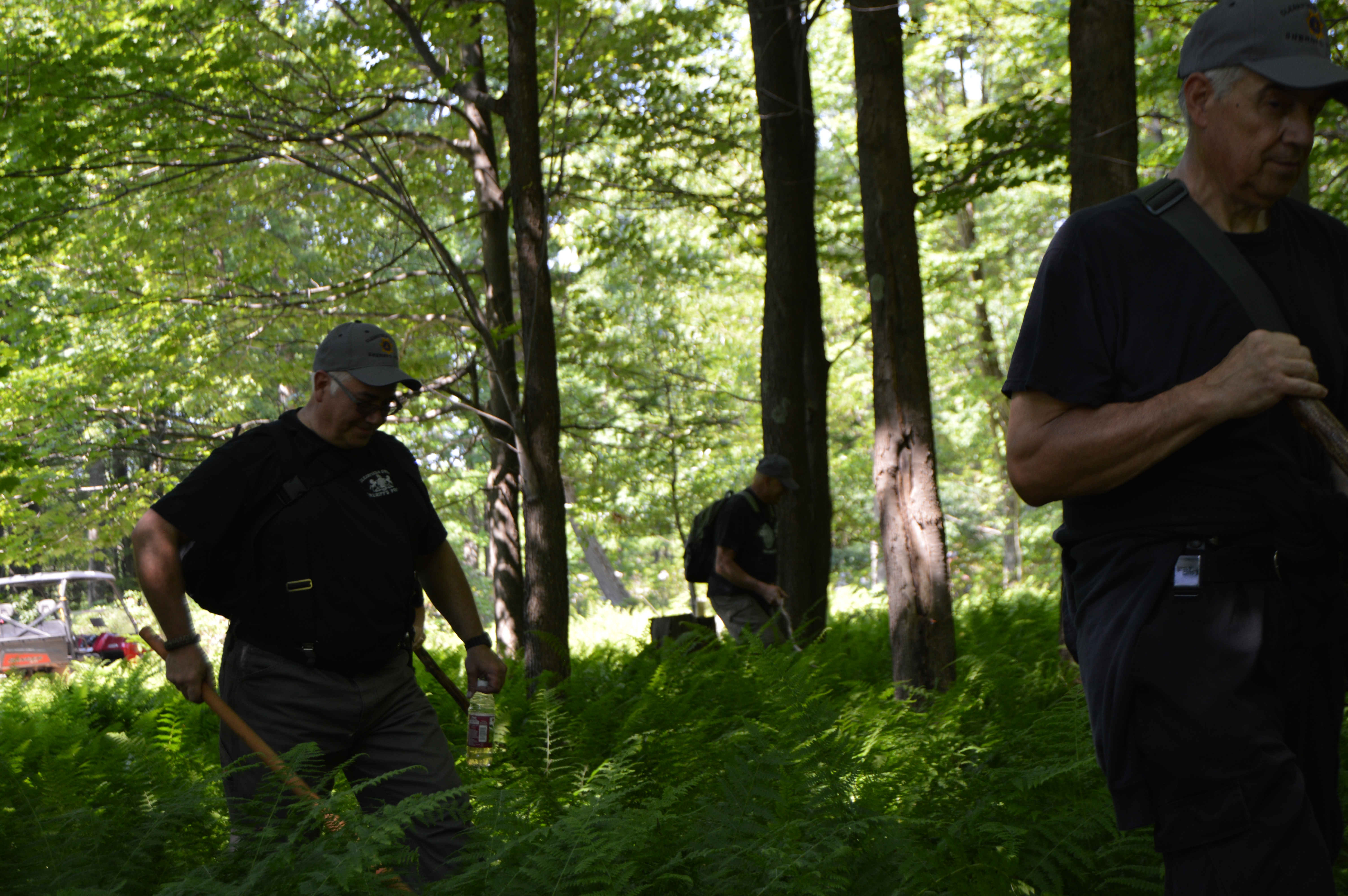 Members of the Clearfield County Sheriff's Posse move methodically through the forest near the Greenwood Club near Curwensville during a mock training exercise. The posse was on the look-out for a 7-year-old girl and any signs she may have passed through the area. The posse also had to be mindful of rattlesnakes and other potential hazards they may encounter while out on a real assignment. (Photo by Kimberly Finnigan)