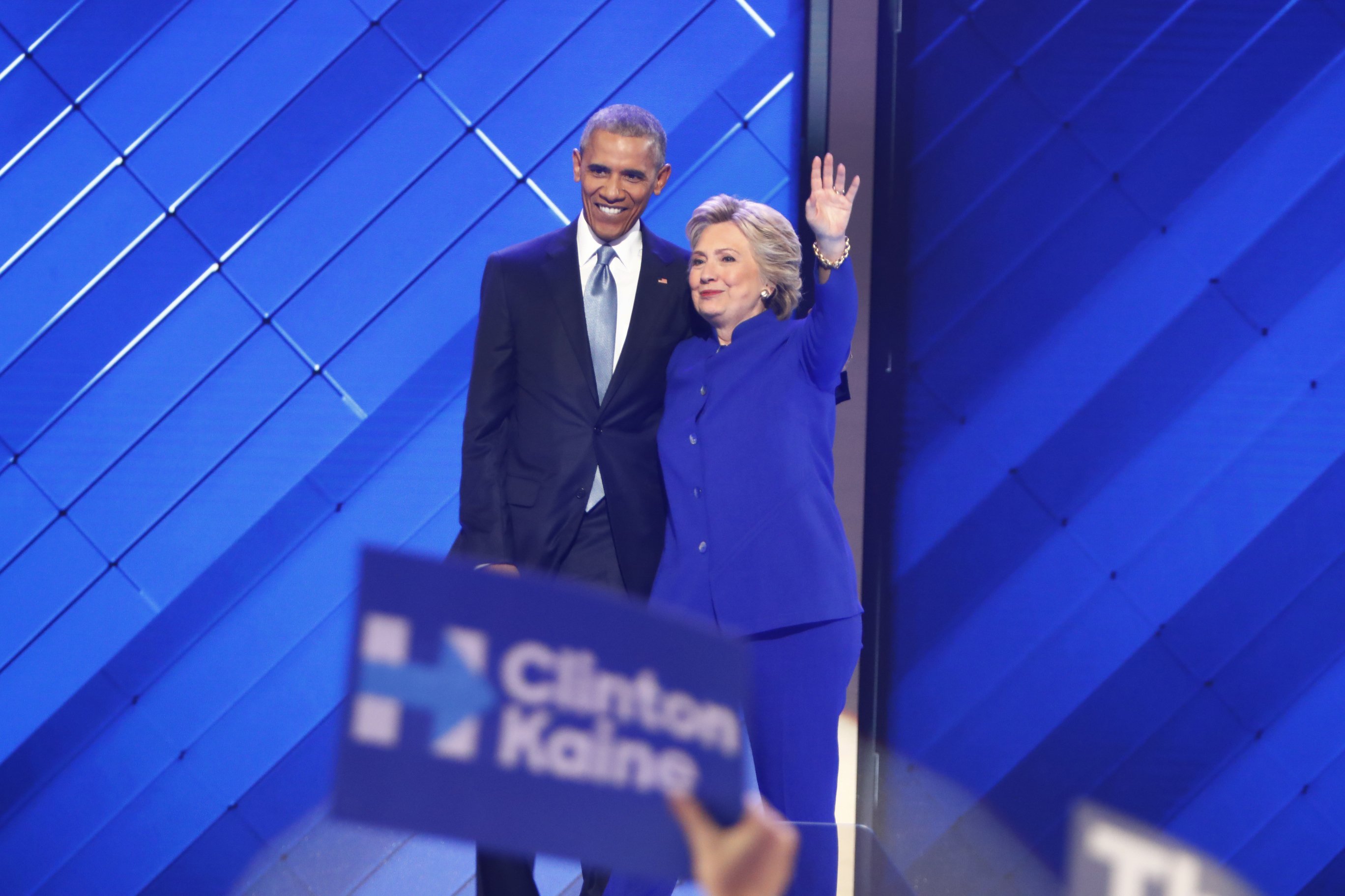 President Barack Obama stands with Hillary Clinton on the stage of 2016 Democratic National Convention.