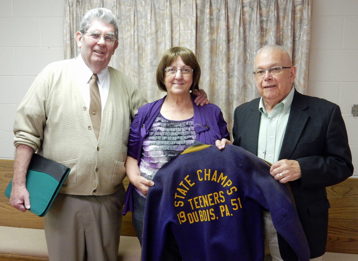 From left are: guest speaker Jack Green, DuBois Area Historical Society President Ruth Gregori holding the state championship jacket, and Joe Vesnesky. (Provided photo)