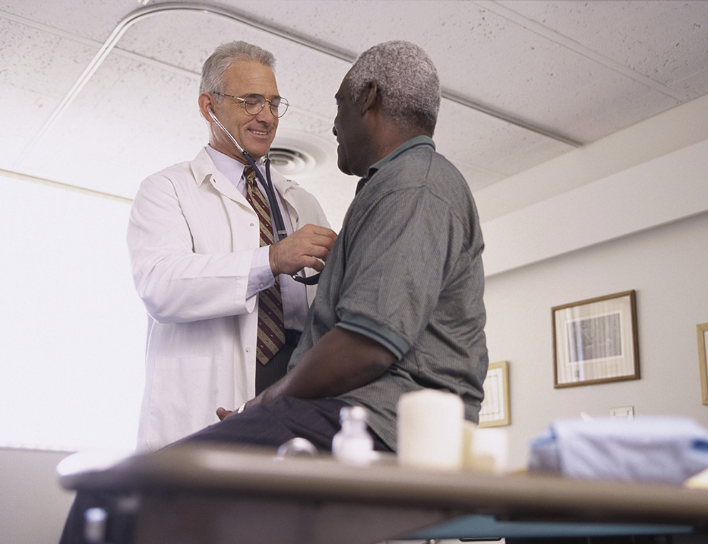 Male doctor examining a male patient