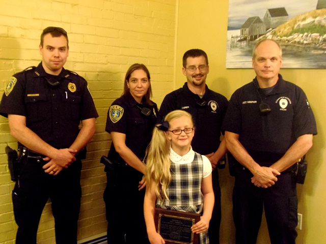 Pictured with Lilly Merrow are Officers Elliott Neeper and Julie Curry of the Lawrence Township police and Officer Nathan Curry and Sergeant Greg Neeper of the Clearfield Borough police. (Photo by Jessica Shirey)
