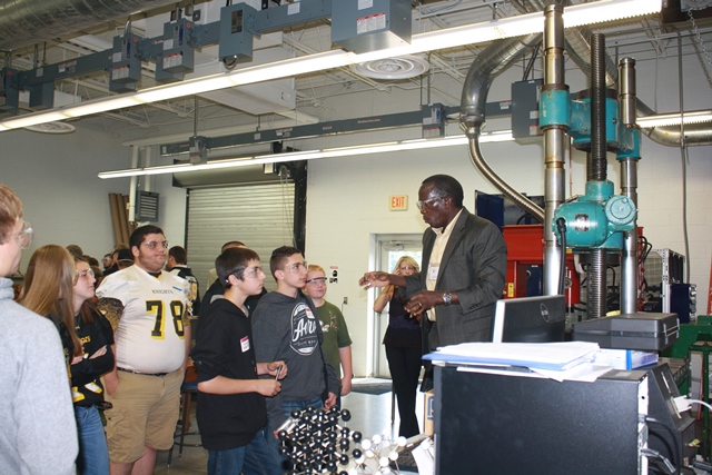 Penn State DuBois Assistant Professor of Engineering Daudi Waryoba explains the production process of powder metal parts during a Manufacturing Day presentation.  (Provided photo)