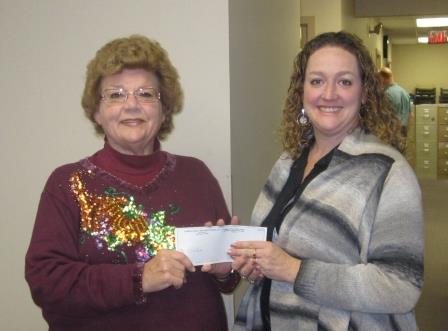 Jeanne Urban (left) representing the Clearfield’s Women’s Club is shown presenting a $100 check to Rikki Ross (right), director of planning and marketing for the Clearfield County Area Agency on Aging Inc.  (Provided photo)