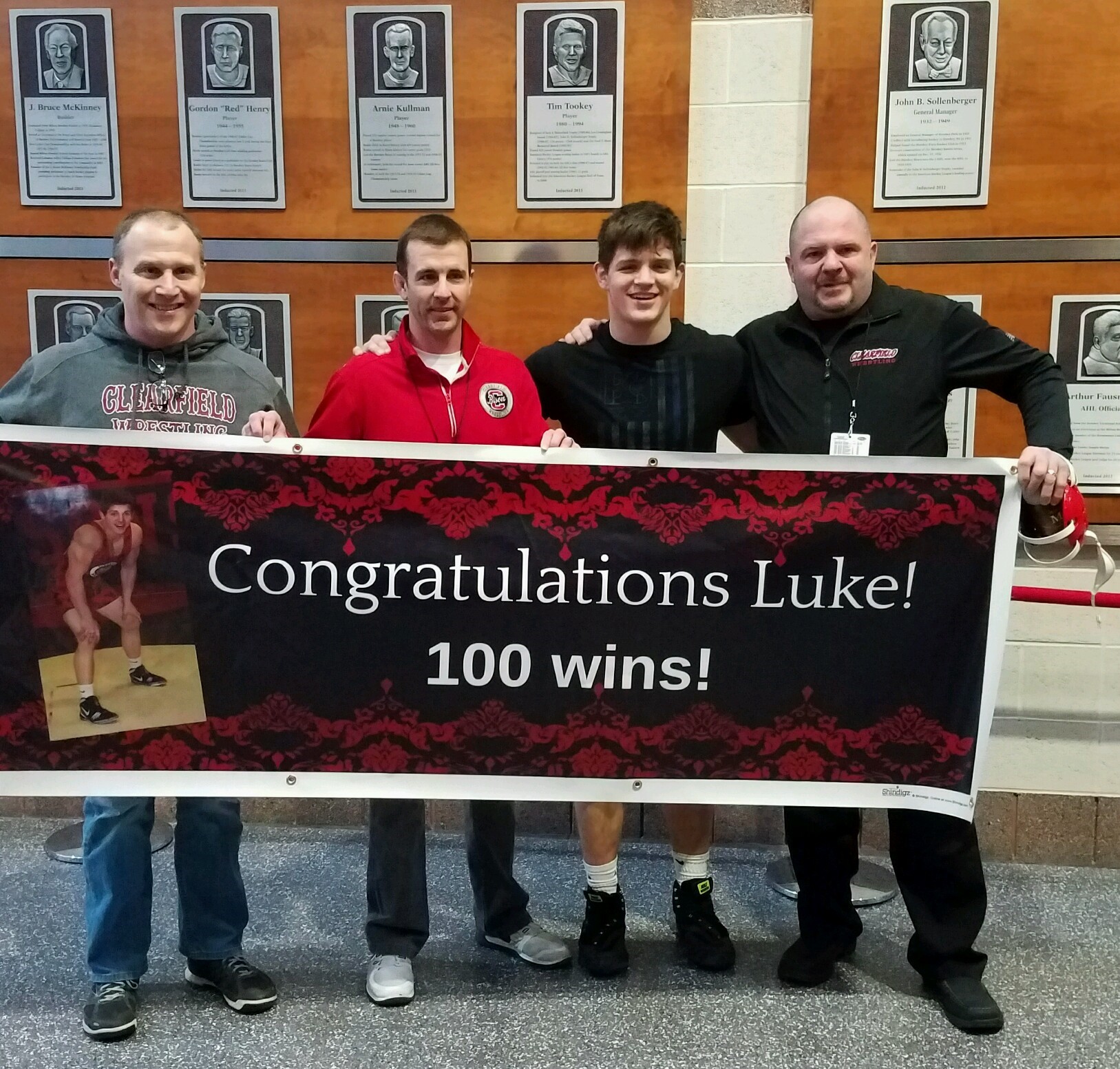 Clearfield Bison wrestler Luke McGonigal won his 100th career match in the semifinals. Shown here with varsity coaches Brent Lykens, Andy Squires, McGonigal, Jeff Aveni. (Photo by Angel Kalke)