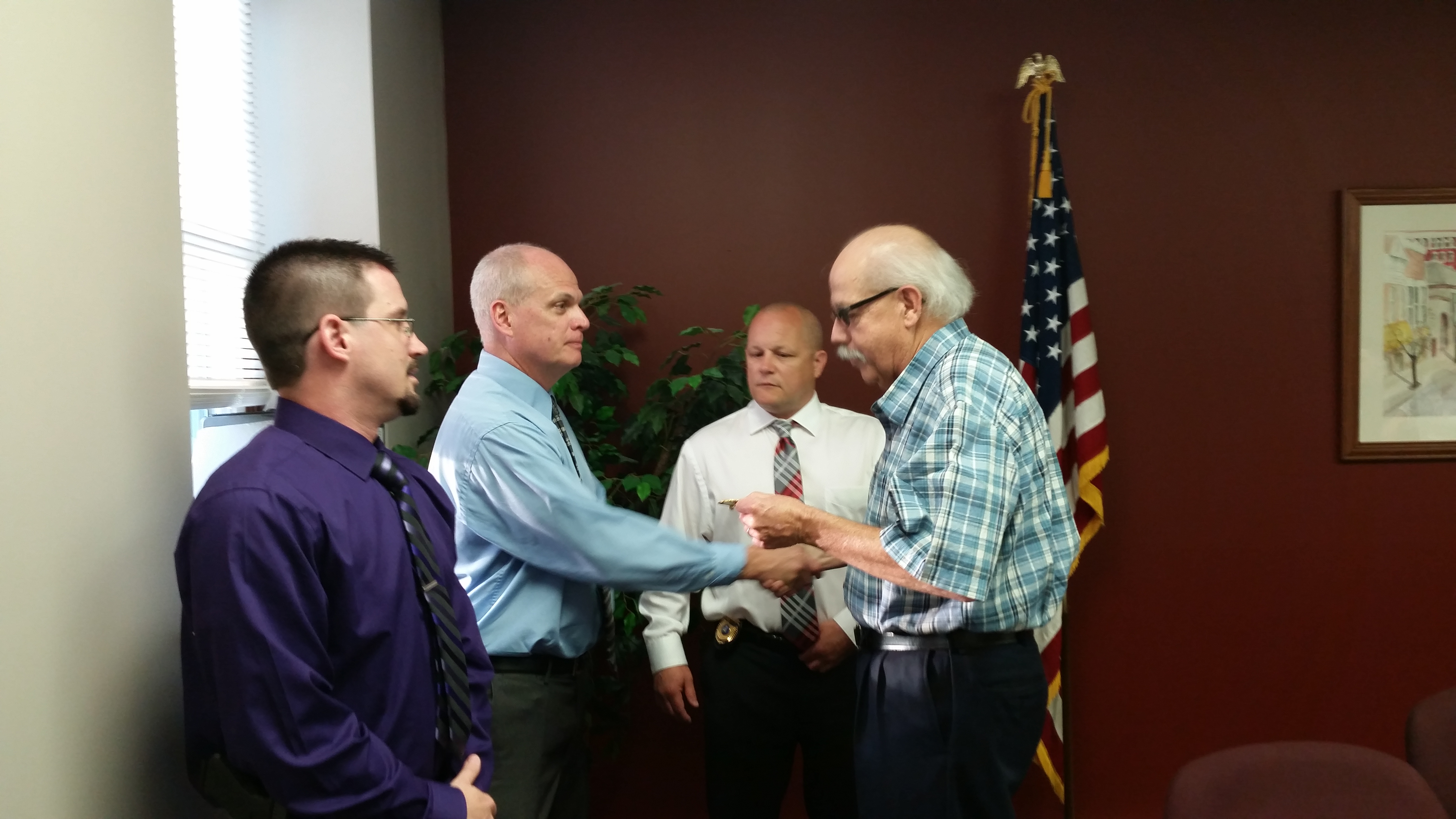 Clearfield Borough Mayor Jim Schell, (right), and Police Chief Vince McGinnis (right center) presented  badges to newly-appointed Assistant Police Chief Greg Neeper (left center), and newly-appointed Police Sergeant Nathan Curry (left) at Thursday's Clearfield Borough Council meeting. Neeper  and Curry will take their new positions April 22. (photo by Kimberly Finnigan)