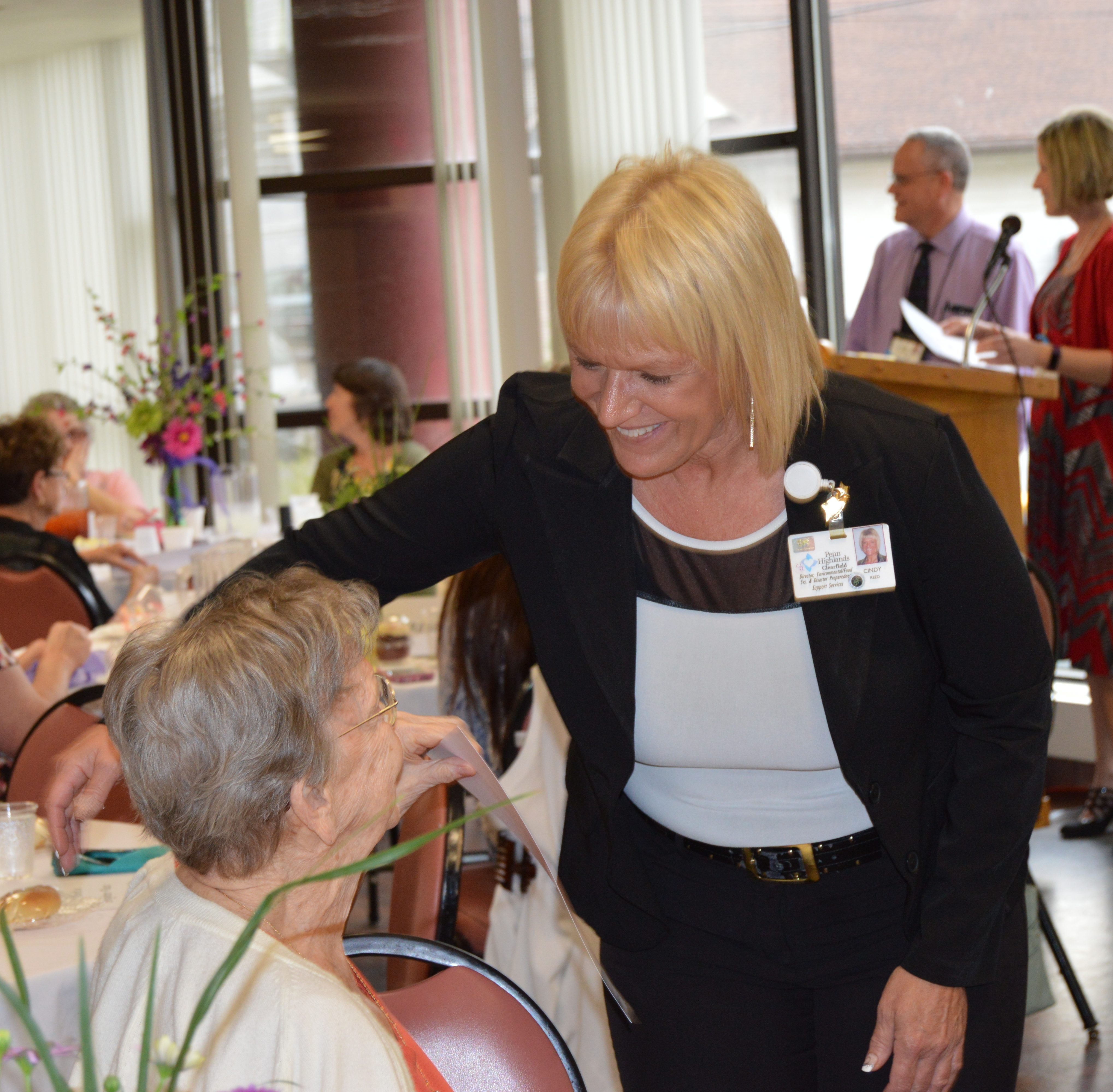 Mauzzy Mohney, left, receives a certificate of appreciation and a hug from Cindy Reed, right, during the annual Volunteer Recognition Dinner at Penn Highlands Clearfield on Thursday. Mohney has been an escort volunteer at the hospital for about 9 years and firmly believes that "everyone is a volunteer, they just don't know it yet." (Photo by Kimberly Finnigan)