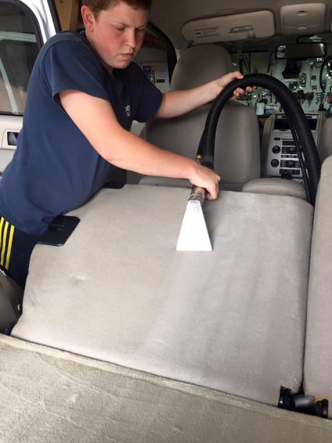 Penn State DuBois graduate and owner of Kristy's Krystal Klean Kars, Kristy Hanes, works to detail the interior of a customer's car at her business in Kersey. (Provided photo)