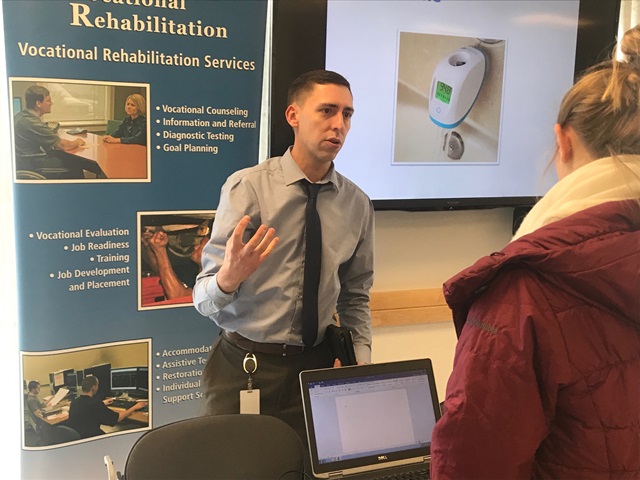 Assistant District Administrator with the Office of Vocational Rehabilitation Mike Jacobson demonstrates new technology that can help people to complete tasks at work, or at home, at Penn State DuBois on Thursday. (Provided photo)