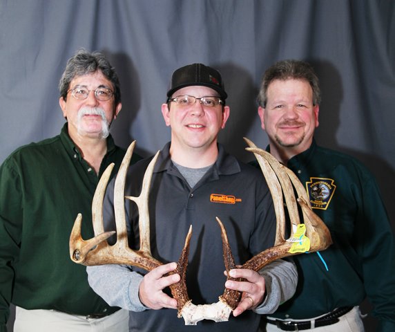 Ron Shaulis is shown holding his record-breaking typical whitetail deer rack taken with a compound bow on Oct. 24, 2017. From left are: Official Boone and Crockett Club scorer Ray Brugler, Ron, and Game Commission Big-Game Scoring Program Coordinator and official B&C Club scorer Bob D’Angelo. (Provided photo)