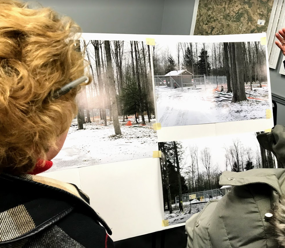 Citizens are shown looking at photos of the Bimini facility that the Hooven’s brought to the Sandy Township Supervisors’ meeting on Monday night. (Photo by Steven McDole)