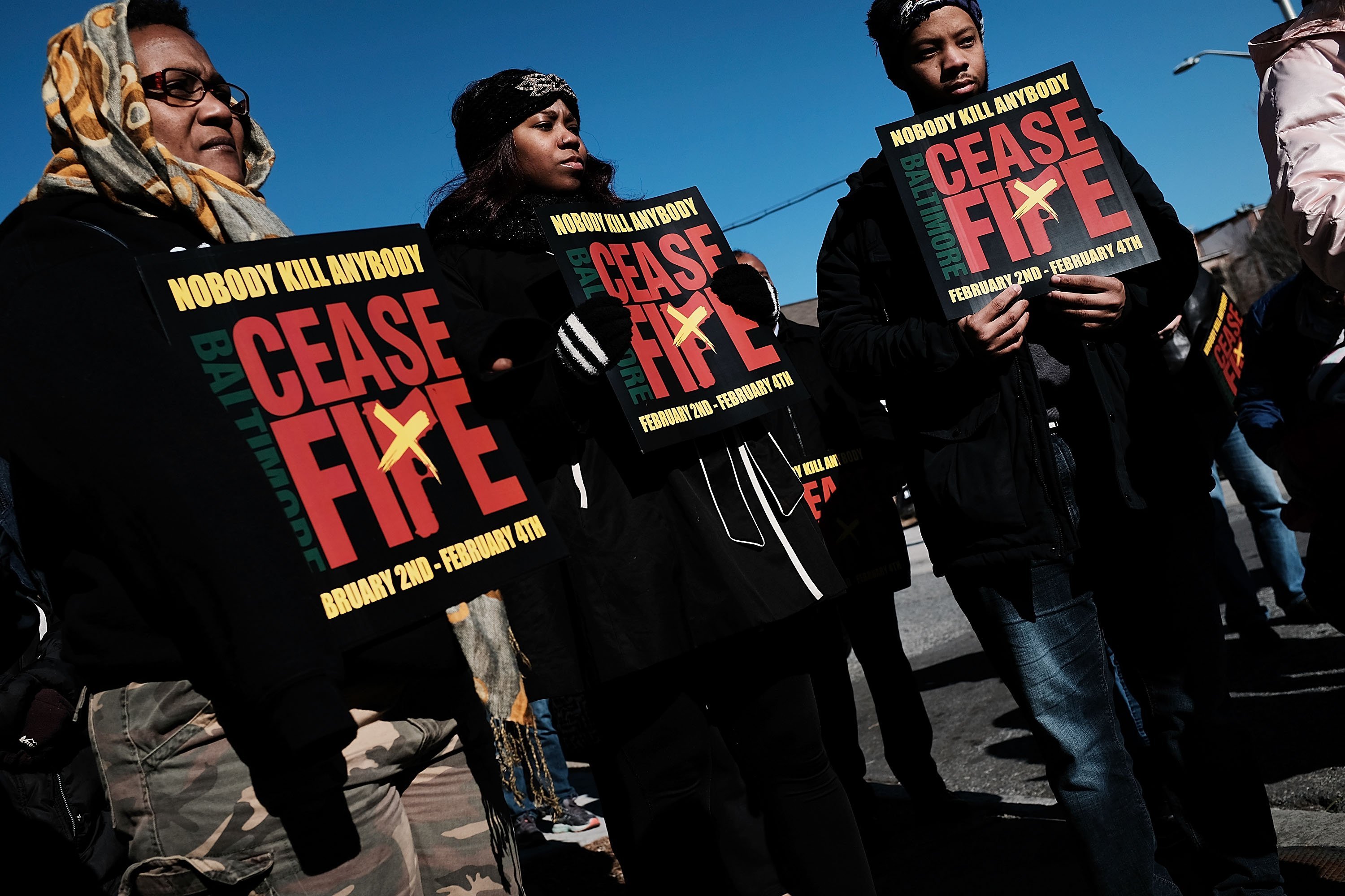 Activists and residents participate in a "Peace and Healing Walk" in an area with a high rate of homicides in Baltimore on February 3, 2018.