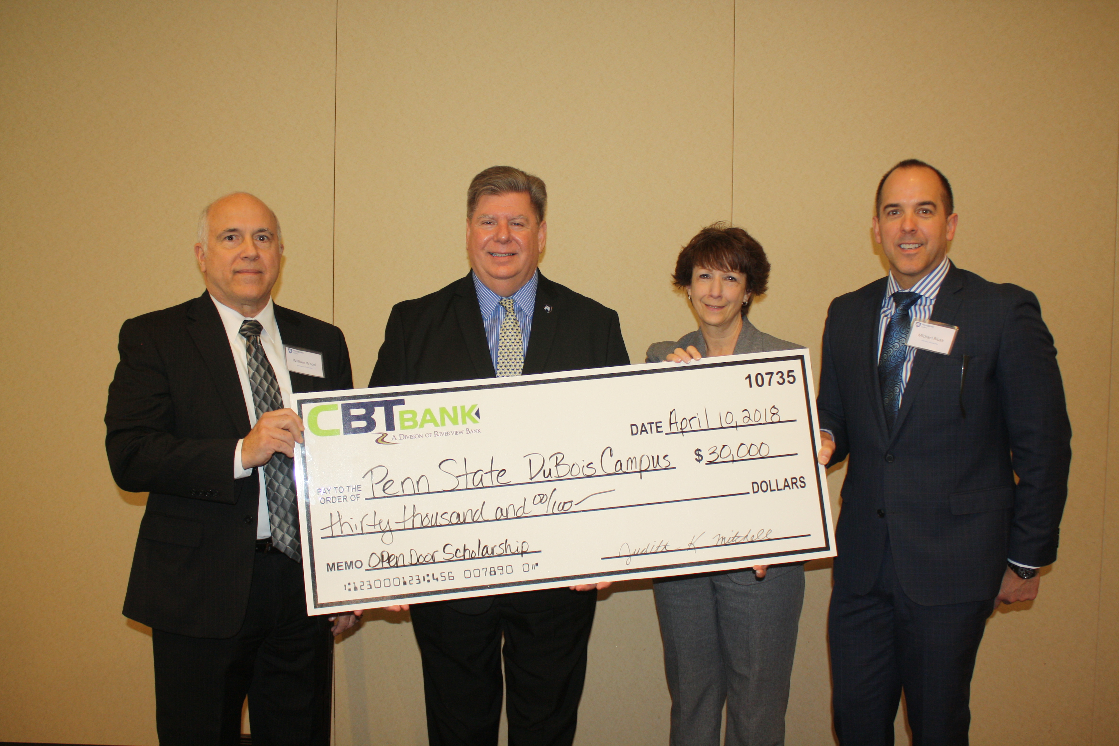 Chancellor M. Scott McBride recently accepted a $30,000 pledge from representatives from CBT/Riverview Bank to establish an Open Doors Scholarship.  Pictured, left to right, are William Wood, CBT Bank; McBride; Judy Mitchell, and Michael Bibak, both with CBT Bank.  (Provided photo)