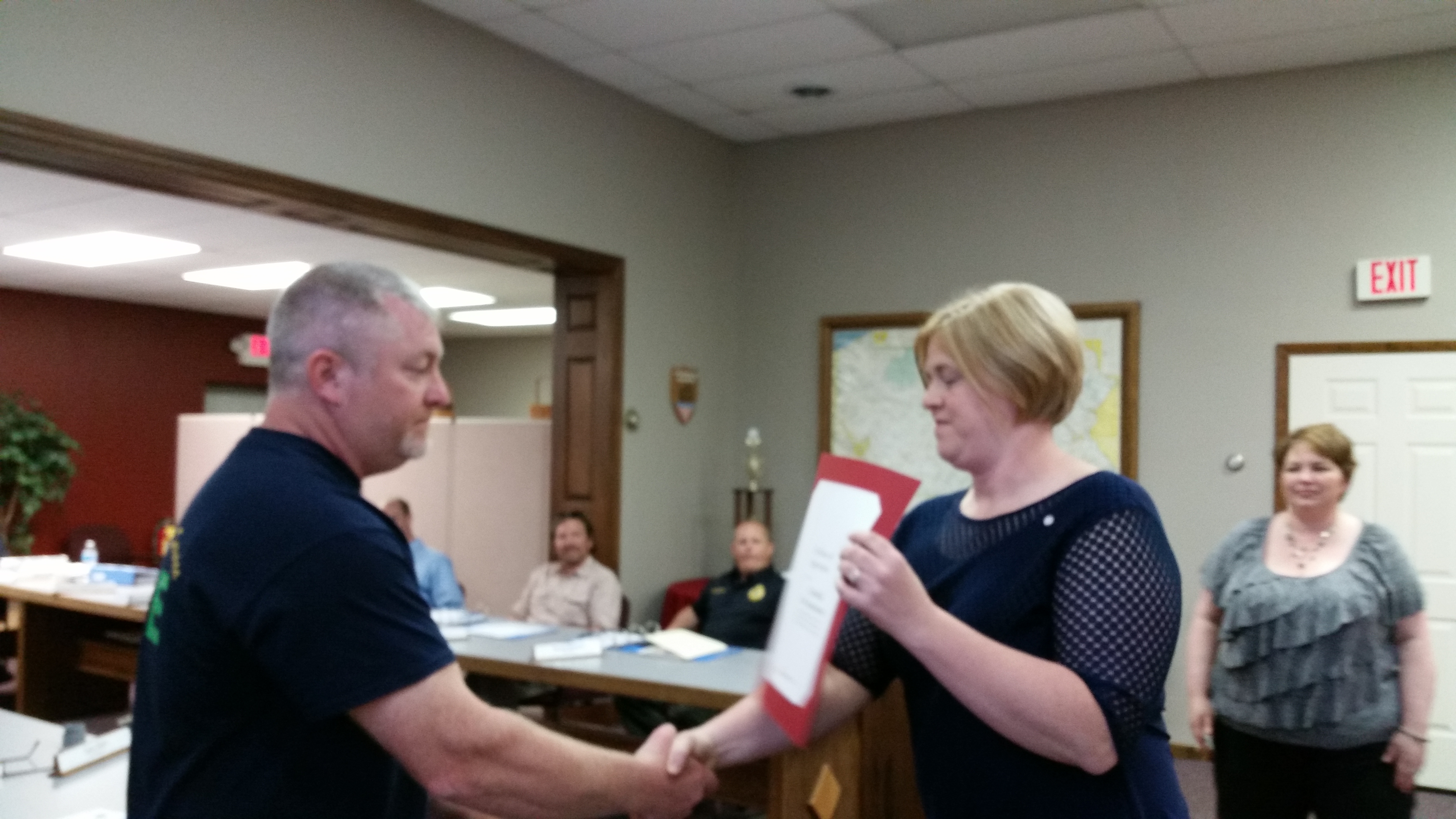 Clearfield Borough Fire Chief Todd Kling, left, accepts a certification of appreciation from Beth Sawyer ,center, of the American Cross. Sawyer also presented a certificate to Borough Operations Manager Leslie Stott, right. The fire department and the borough worked with the Red Cross April 28 to install 541 smoke detectors in 135 homes. (Photo by Kimberly Finnigan)