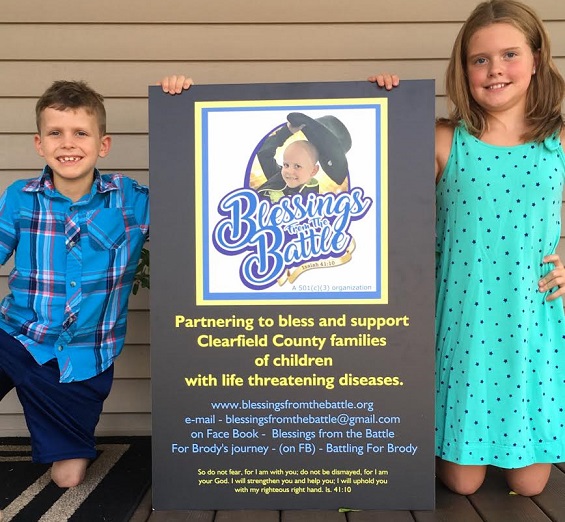 Brody Lanich and his big sister, Khloe, proudly display a poster introducing the Blessings from the Battle Foundation founded by the Lanich, Gabel and Bressler families to support and bless children and families of Clearfield County dealing with serious medical diagnoses. (Provided photo)
