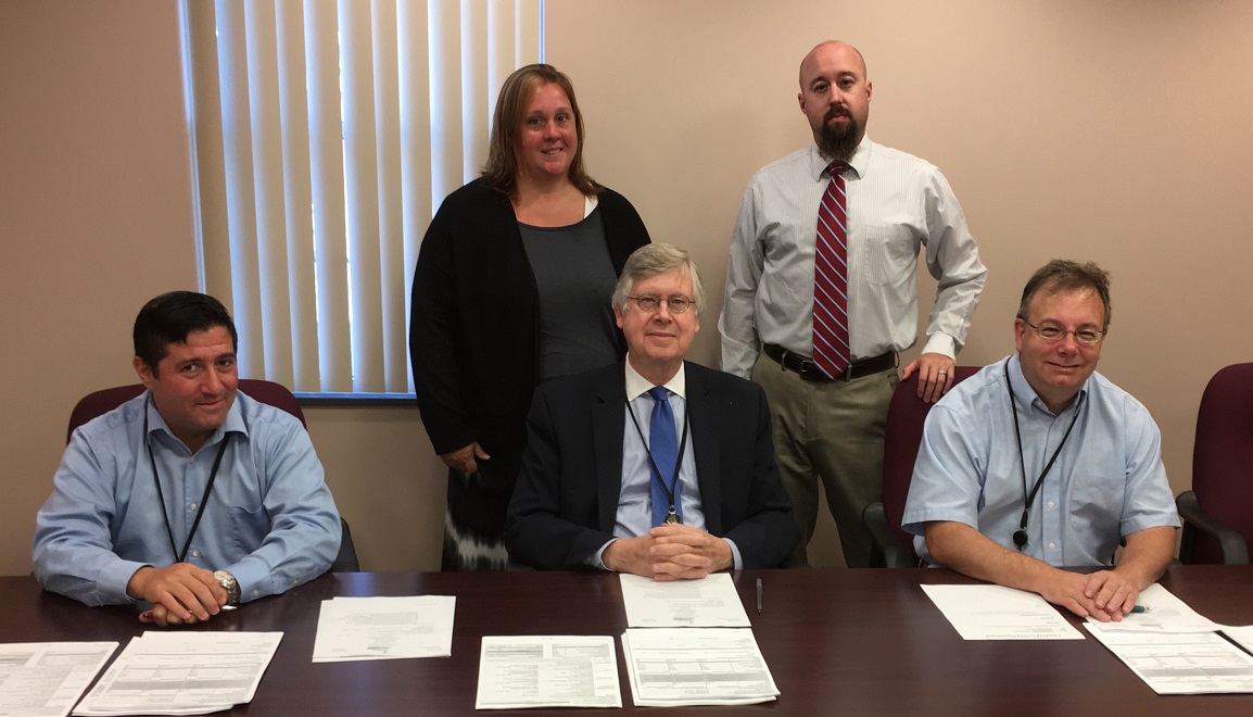 Pictured, in front are Clearfield County Commissioners Tony Scotto, John A. Sobel, chairman, and Mark B. McCracken. In the back are Leslie Smeal, new CYS director, and Jay Hamilton, current CYS Director. (Photo by GANT News Editor Jessica Shirey)