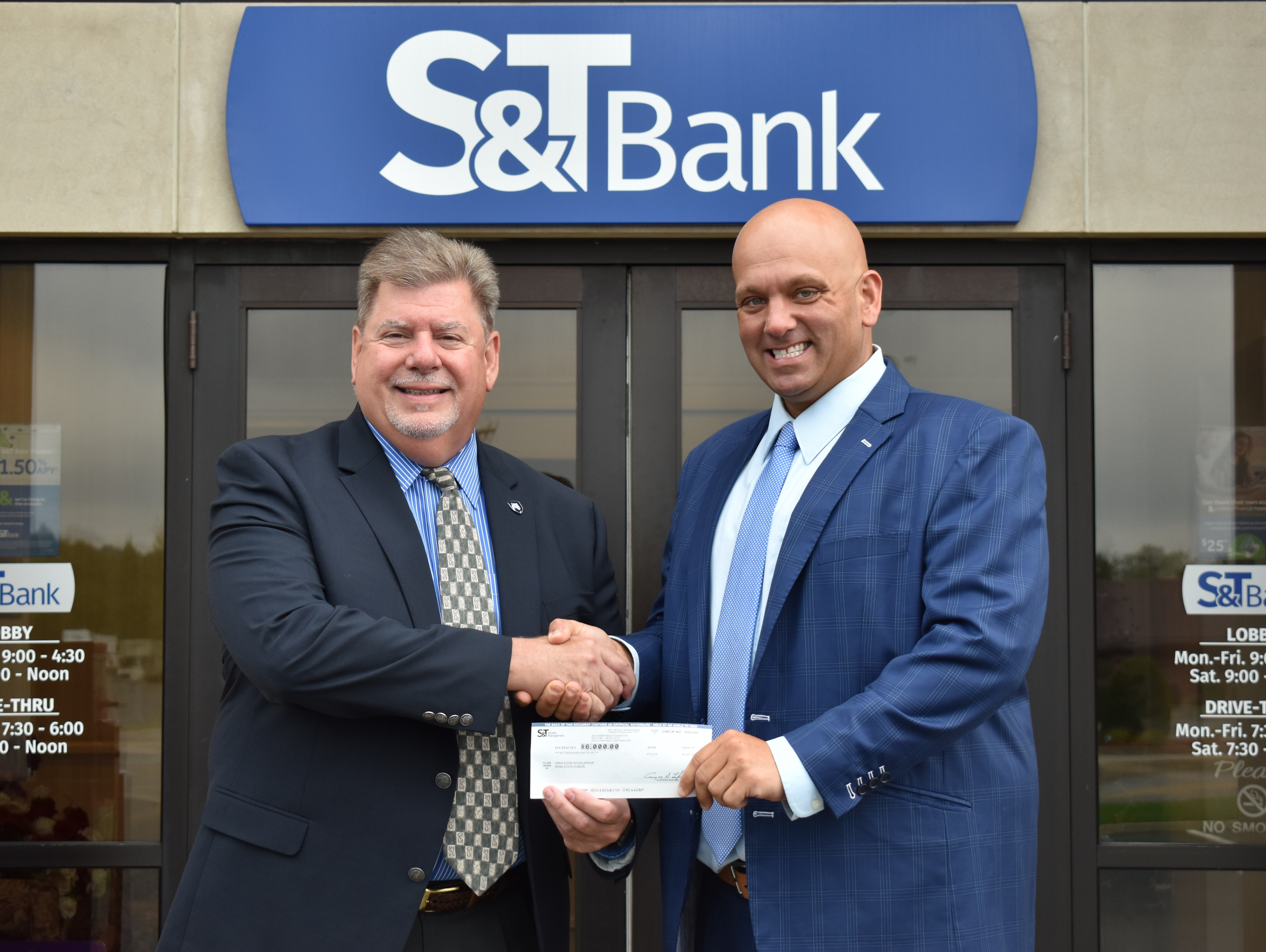 Chancellor M. Scott McBride, left, accepts a $30,000 check from S&T Bank’s Senior Vice President and Commercial Banker Daniel Baronick to establish the S&T Bank Open Doors Scholarship. (Provided photo)