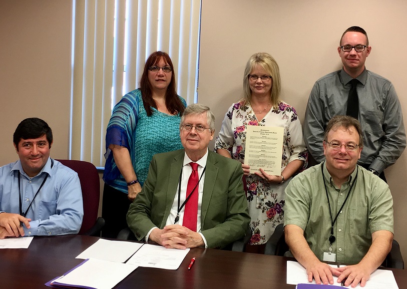 Pictured, in front, are Clearfield County Commissioners Tony Scotto, Chairman John A. Sobel and Mark B. McCracken. In the back are Crossroads Director Suella Himes, Counselor/Legal Advocate Tammy Kyler and Domestic Violence Services Coordinator Shawn Day. (Photo by GANT News Editor Jessica Shirey)