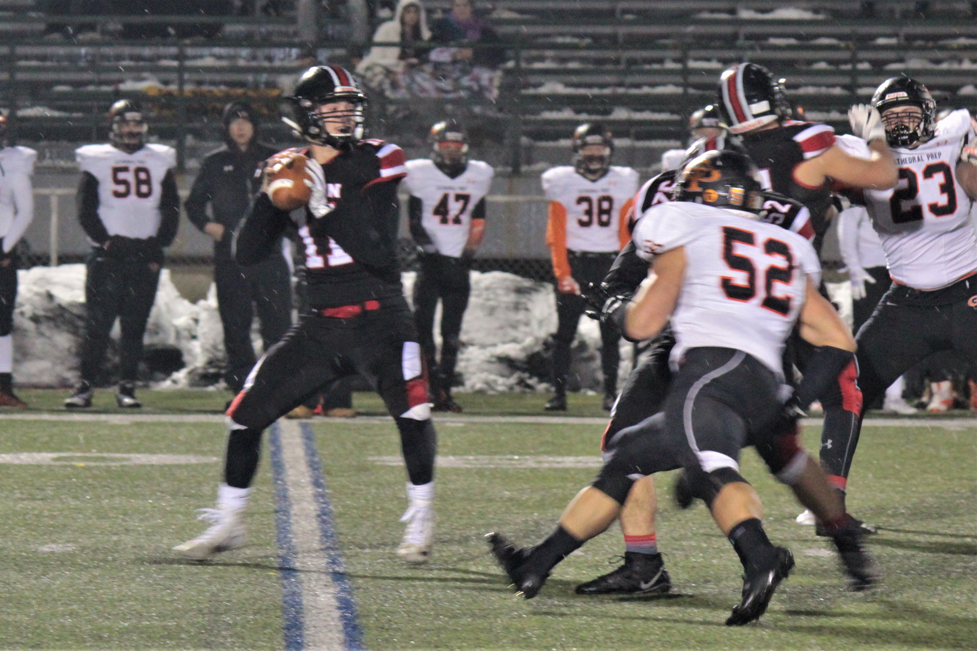 Isaac Rumery looks to his right for a receiver early against Cathedral Prep.  He finished with 122 yards passing, but did not finish the game.