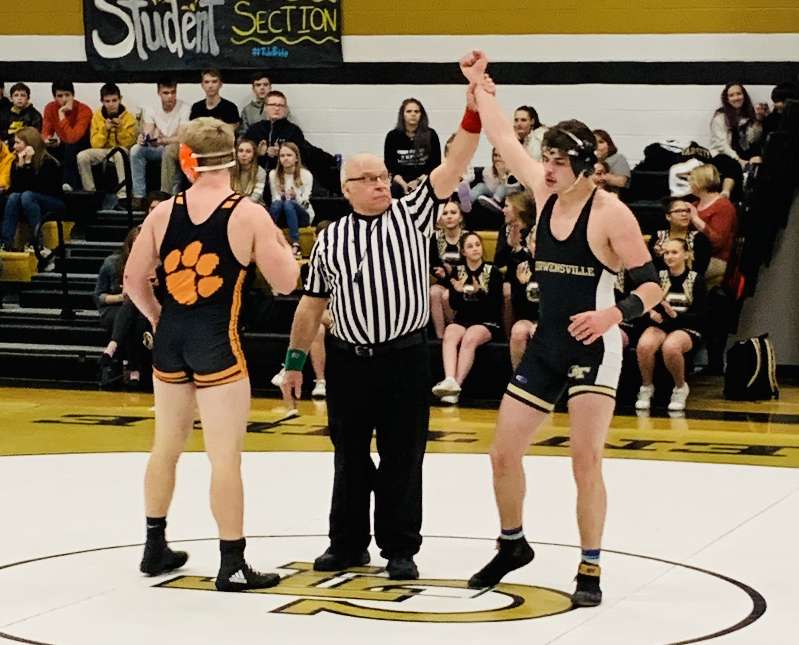Sophomore Jake McCracken gets his hand raised with a last second come from behind win. (Photo by HL)