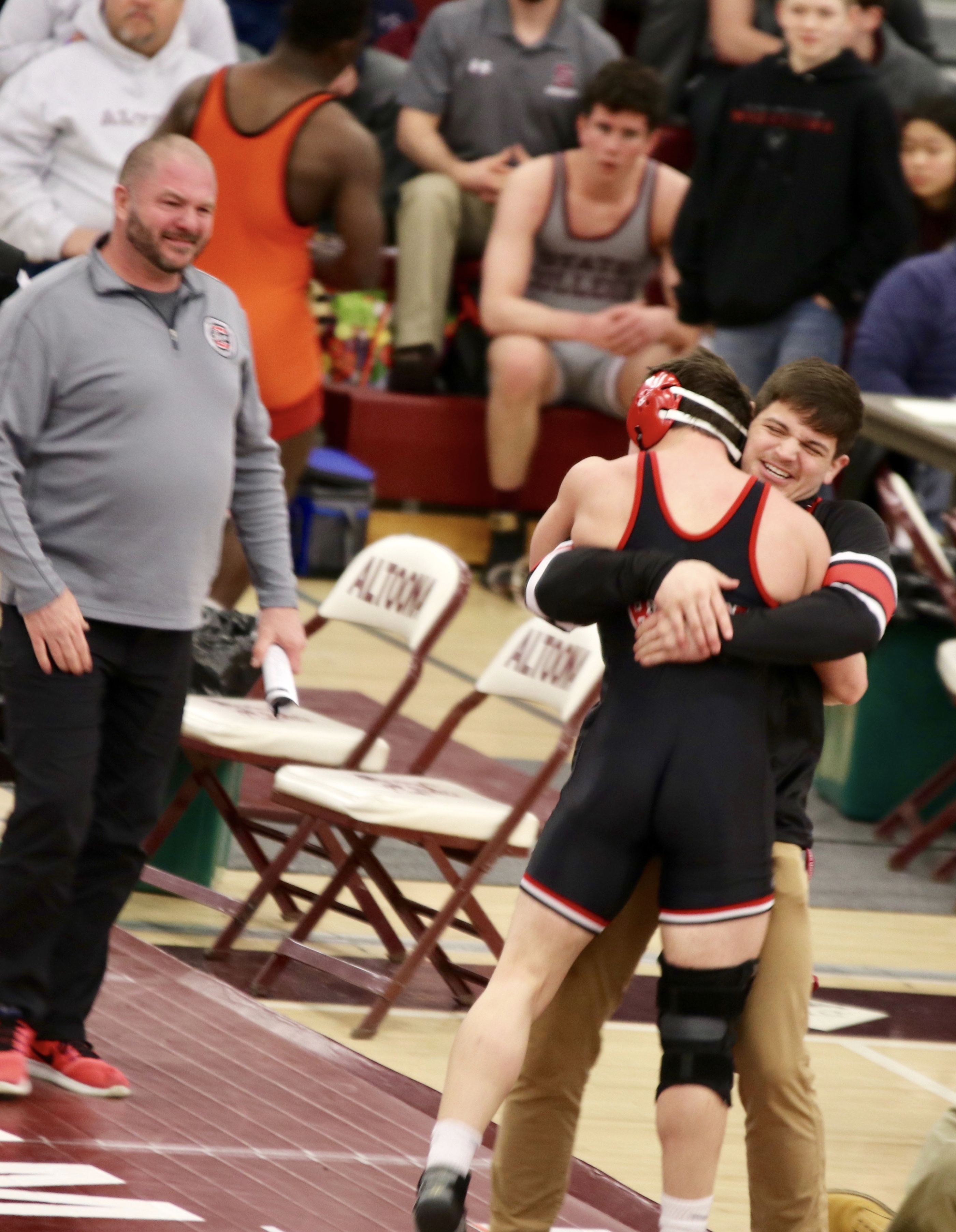 Mark Mcgonigal jumps into the arms of his brother Luke after winning his regional semi-finals bout. This will be the fifth year in a row with a McGonigal boy making noise at the PIAA State Tournament.