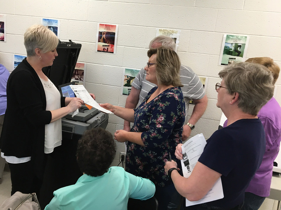 Centre County Election Coordinator Jodi Nedd, left, demonstrates how to scan a hand-marked paper ballot. (Provided photo)