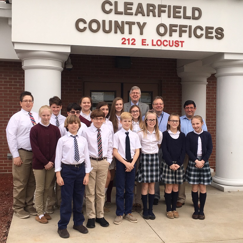 In front, from left, are: Noah Rumfola, Zachary Sproull, Cash Diehl, Sonny Diehl, Sadie Ryan and Haley Custaney.  In the middle row are: Dehlia Elbe, Daniel Jordan, Abby Ryan and McKenna Lanager. In the back are: Owen Dinant, Luke Dixon, Sarah Huegler, Eva Bloom, Commissioner John A. Sobel, Commissioner Mark B. McCracken and Commissioner Tony Scotto. (Photo by GANT News Editor Jessica Shirey)