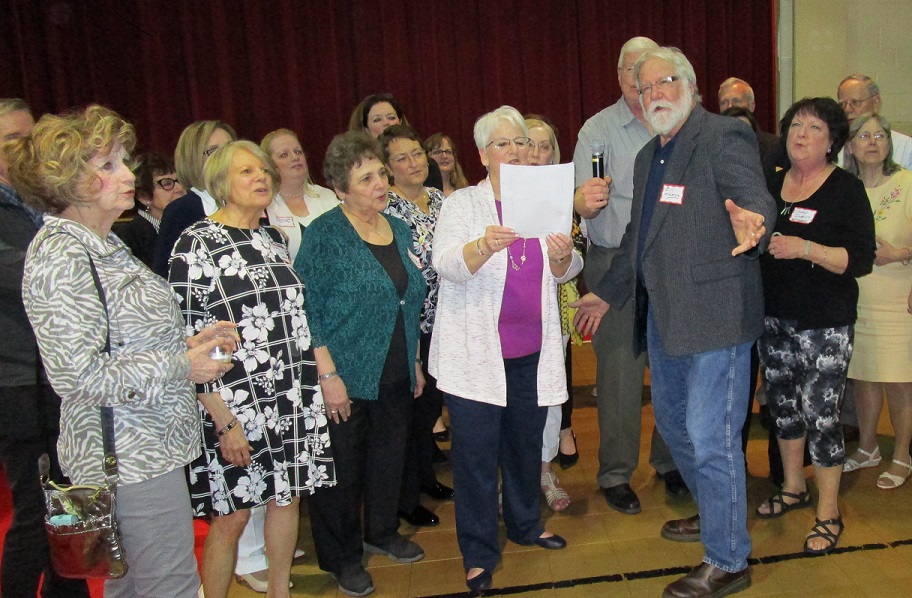 William McNamee, former mayor of Clearfield and member of the class of 1967, leads the singing of the St. Francis School Alma Mater at the alumni reunion held Saturday to celebrate the 125th anniversary of St. Francis School. (Provided photo)
