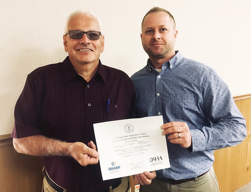 Dave M. Yanoschick Jr., CSP, IUP OSHA Consultation, right, presents the SHARP Certificate to Terry Fustine, safety coordinator, Phoenix Sintered Metals LLC in Brockway. (Provided photo)