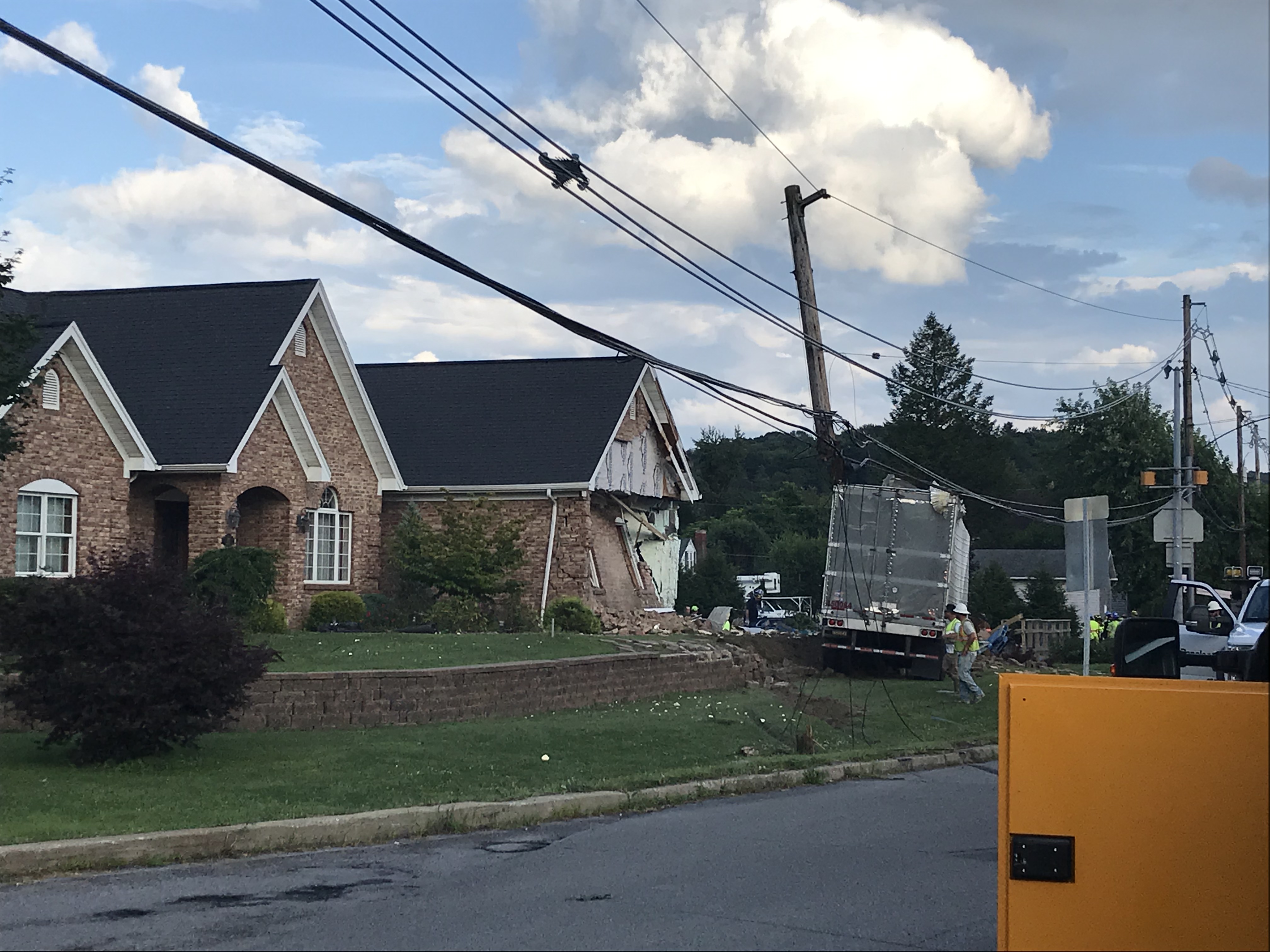 Utility wires dangle from damaged poles following an accident where a tractor trailer struck a house at 201 Race Street in Lawrence Township Tuesday. This is not the first time a tractor trailer has struck houses at this location. In 2007, the driver of a tractor trailer struck three houses on this property when the driver lost his breaks coming down Rockton Mountain. The residents were not home when this accident occurred and the driver was taken to a local trauma center for treatment of undisclosed injuries. (Photo by Christene Dahlem)