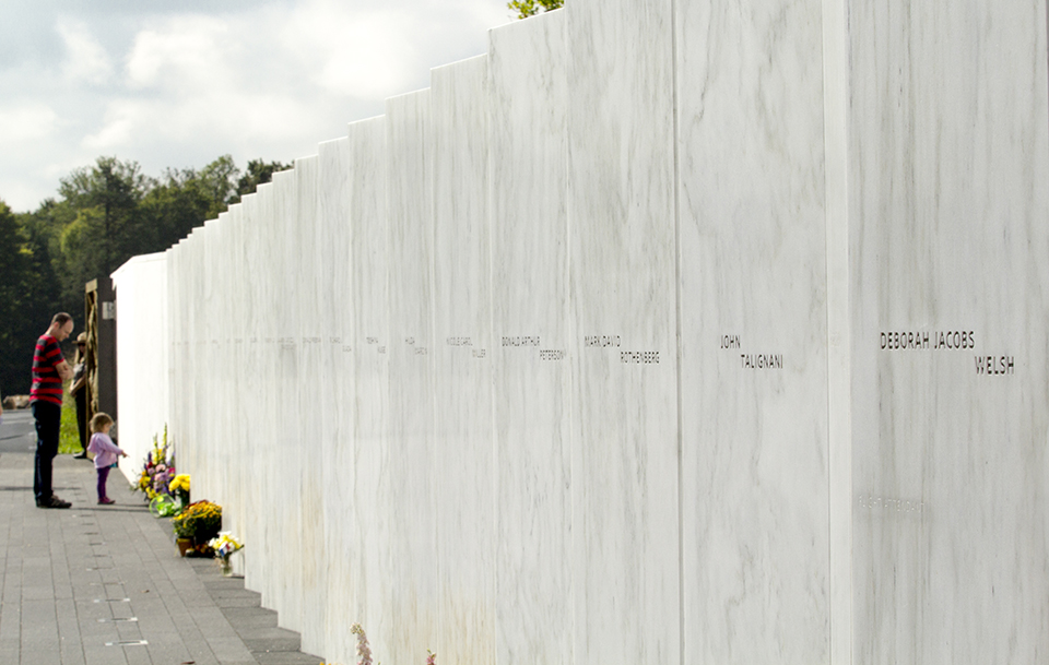 Visitors pay their respects to the 40 passengers and crew members at the Wall of Names.  NPS photo