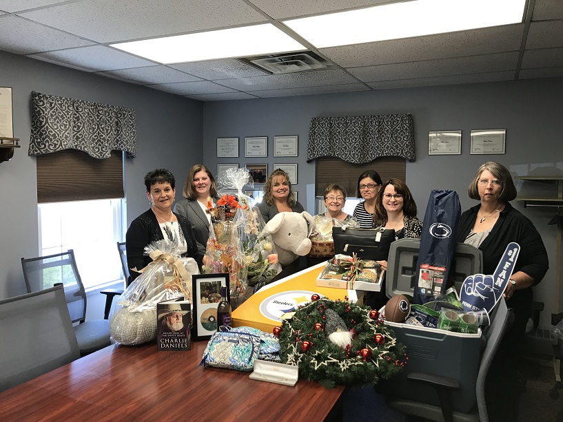 Some of this year’s committee members, (from left to right) Michele Fannin, Missy Bishop, Vicky Myers, Joan Bracco, Kristi Twoey, Ronda Vaughn and Cathie Hugar are showcasing just a few of the items up for bid at this year’s 24th annual Anne S. Thacik Charity Auction. (Provided photo)